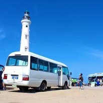 Our small coach parked in front of the beautiful California Lighthouse