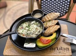 Skillet light. Baked whites-egg with mushrooms, spinach, paprika, coriander and a touch of feta cheese, with avocado, humus and brown bread.