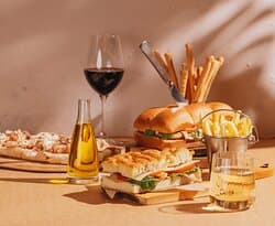 Enjoy beach-view lunch on the patio with delicious sandwiches and pinsas.