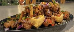 Popcorn Chicken Waffles with peanut sauce, plantain and herbs