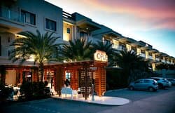 Elegant exterior of Opus Ocean & Grill during golden hour - located in Palm Beach Aruba, our fine dining restaurant specializes in high - end Mediterranean and seafood cuisine