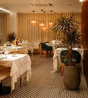 Where natural accent, soft lighting, and a calming ambience create the perfect setting for a luxurious dining experience.