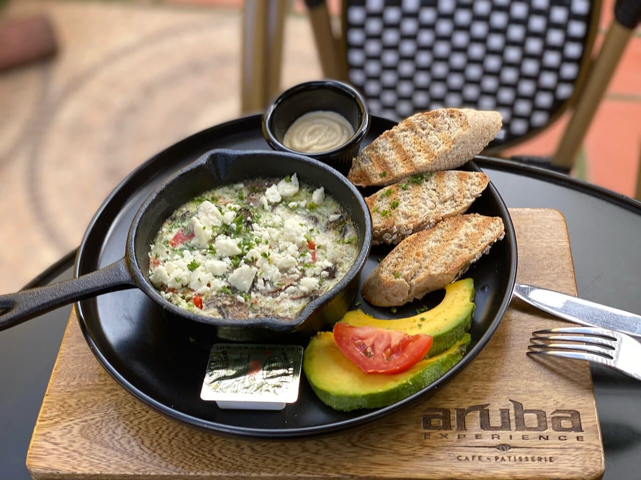 Skillet light. Baked whites-egg with mushrooms, spinach, paprika, coriander and a touch of feta cheese, with avocado, humus and brown bread.
