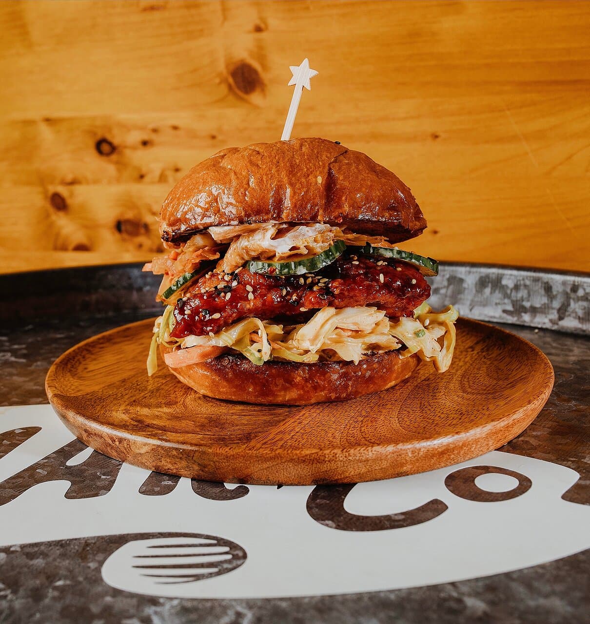 Korean fried chicken sando with your gochujang sauce and our housemade kimchi citrus slaw - a crowd favorite