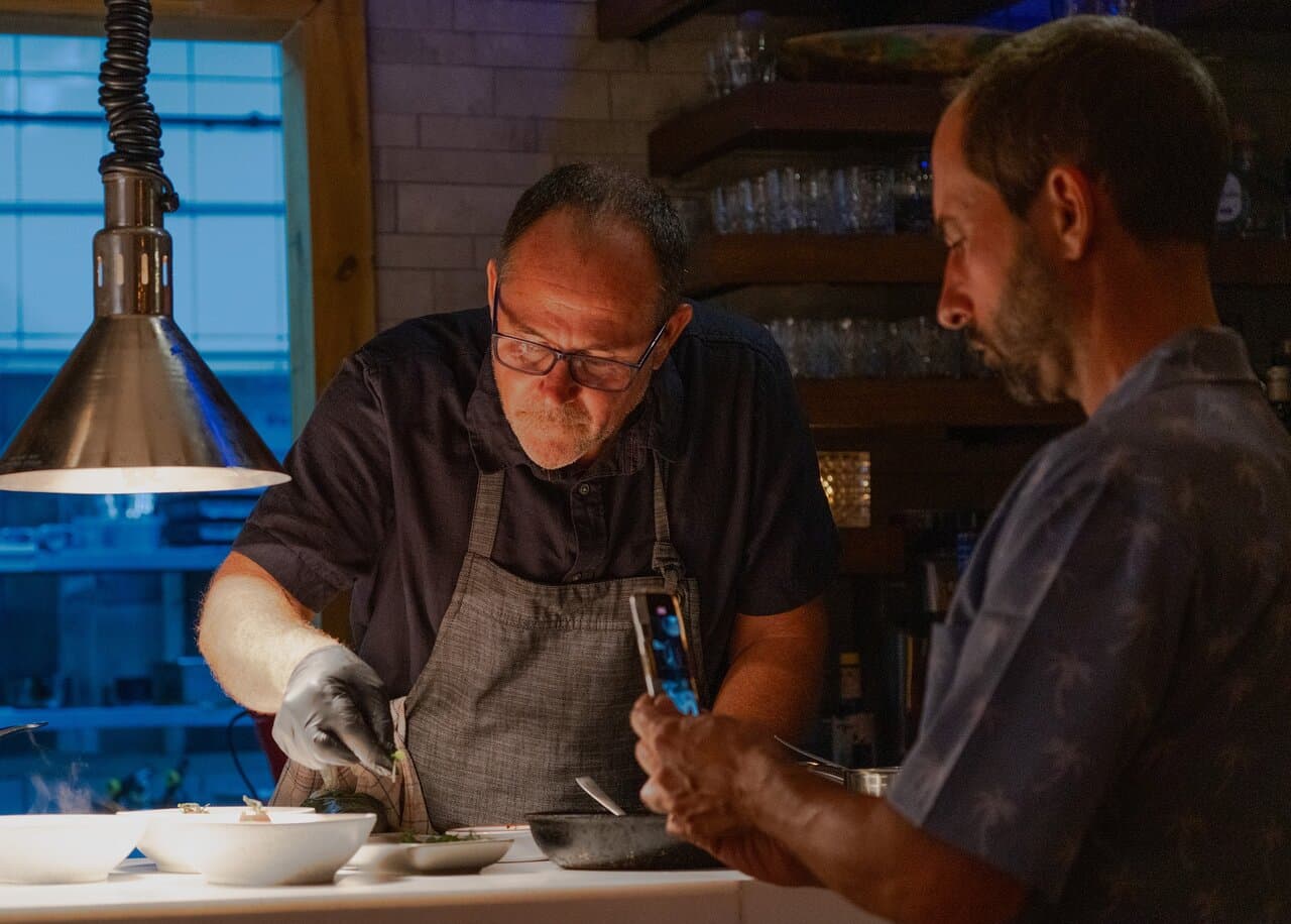 Imagine walking into a space where the kitchen isn’t hidden — it’s the stage. At The Journey Chef’s Table Aruba, you sit just steps away from Chef Patrick as he creates a 5½-course dinner that unfolds like a story. You’ll hear the sizzle, smell the aromas, and even join the conversation. Guests often lean in, ask questions, take photos, and smile as each plate comes to life. It’s not just dining — it’s being part of something truly personal.