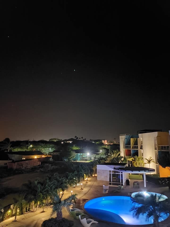 View From balcony.  You can't really see it at night, but during the day you are just looking into someone's front yard and an empty dirt lot.  Not a great view.