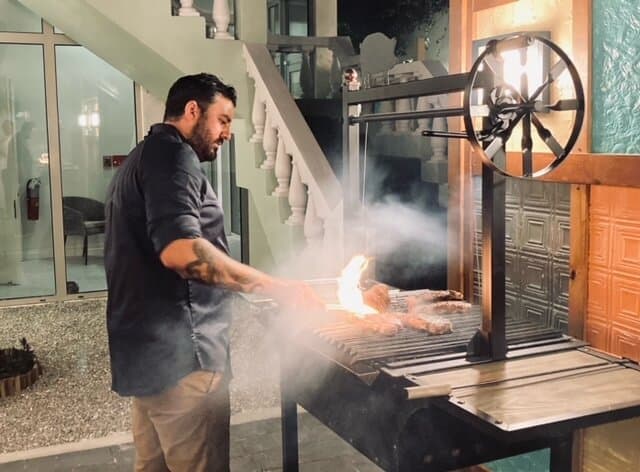 Chef Albert grilling in the restaurant's back garden.