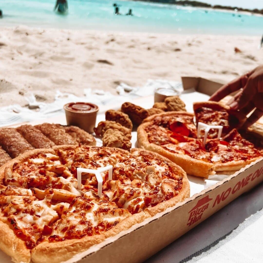 Enjoying a slice of paradise by the beach with Pizza Hut. The perfect combination of sun, sand, and delicious pizza! 🍕🏖️