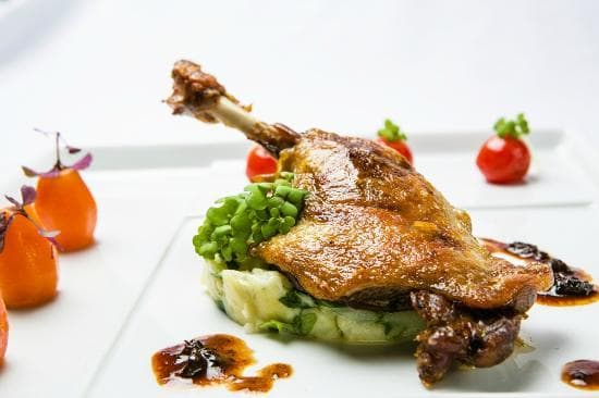 Confit of duck leg, rucola mashed potato, orange-carrots, vanilla grape tomatoes, morel sauce