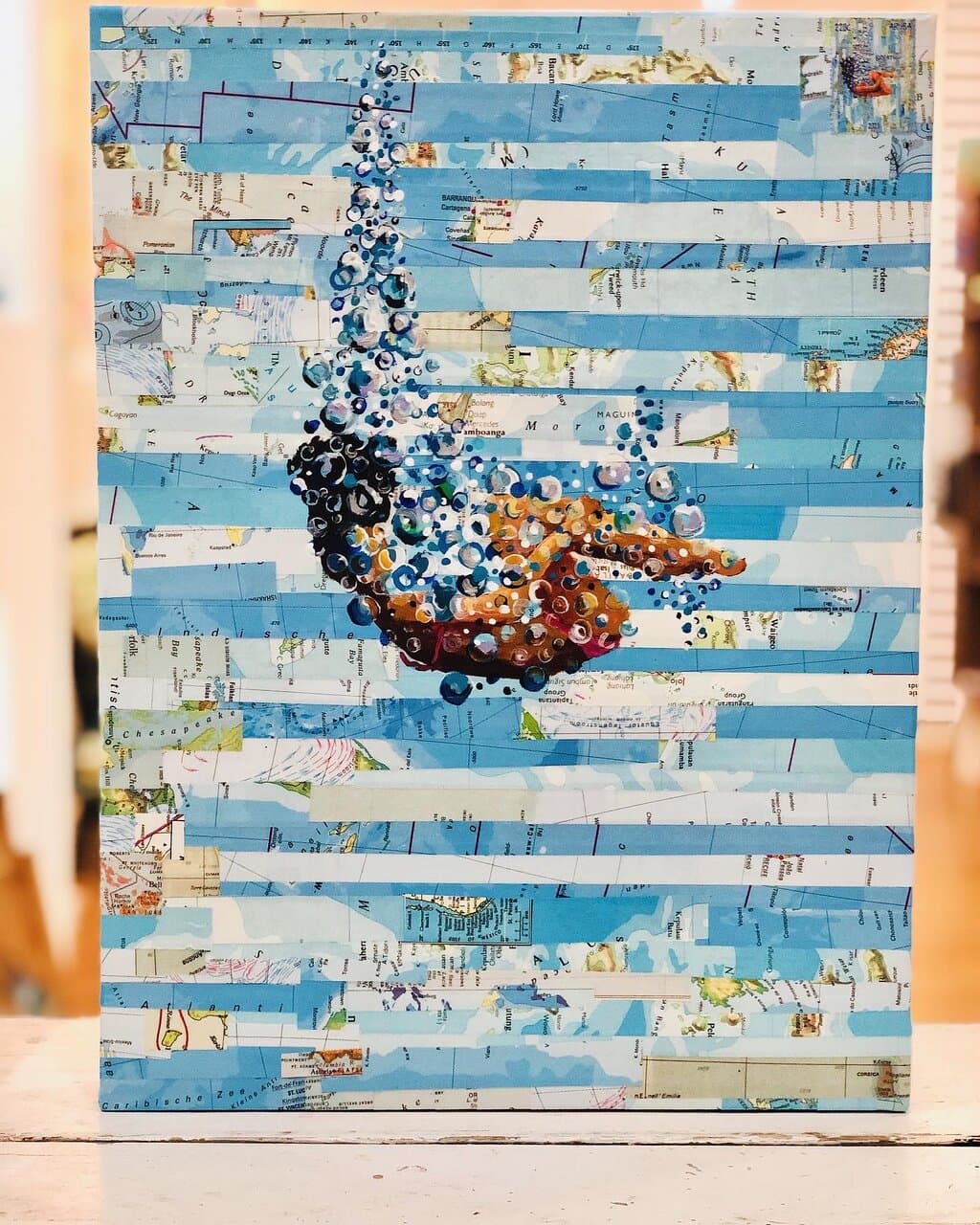 Beautiful painting on old recycled maps .