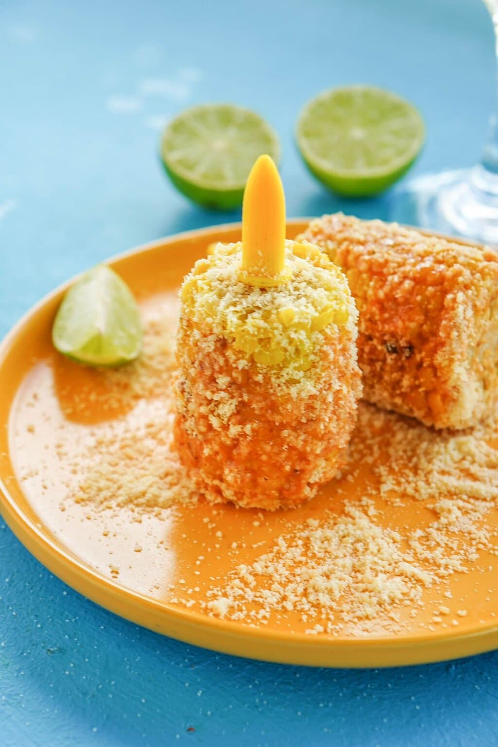 A delightful serving of seasoned corn with a zesty lime garnish.