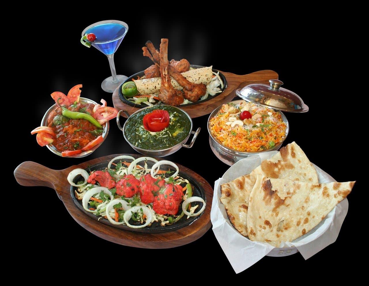 Delicious Lamb chops, Chicken Tikka, Palak Paneer accompanied by Kashmiri Pullao and Naans