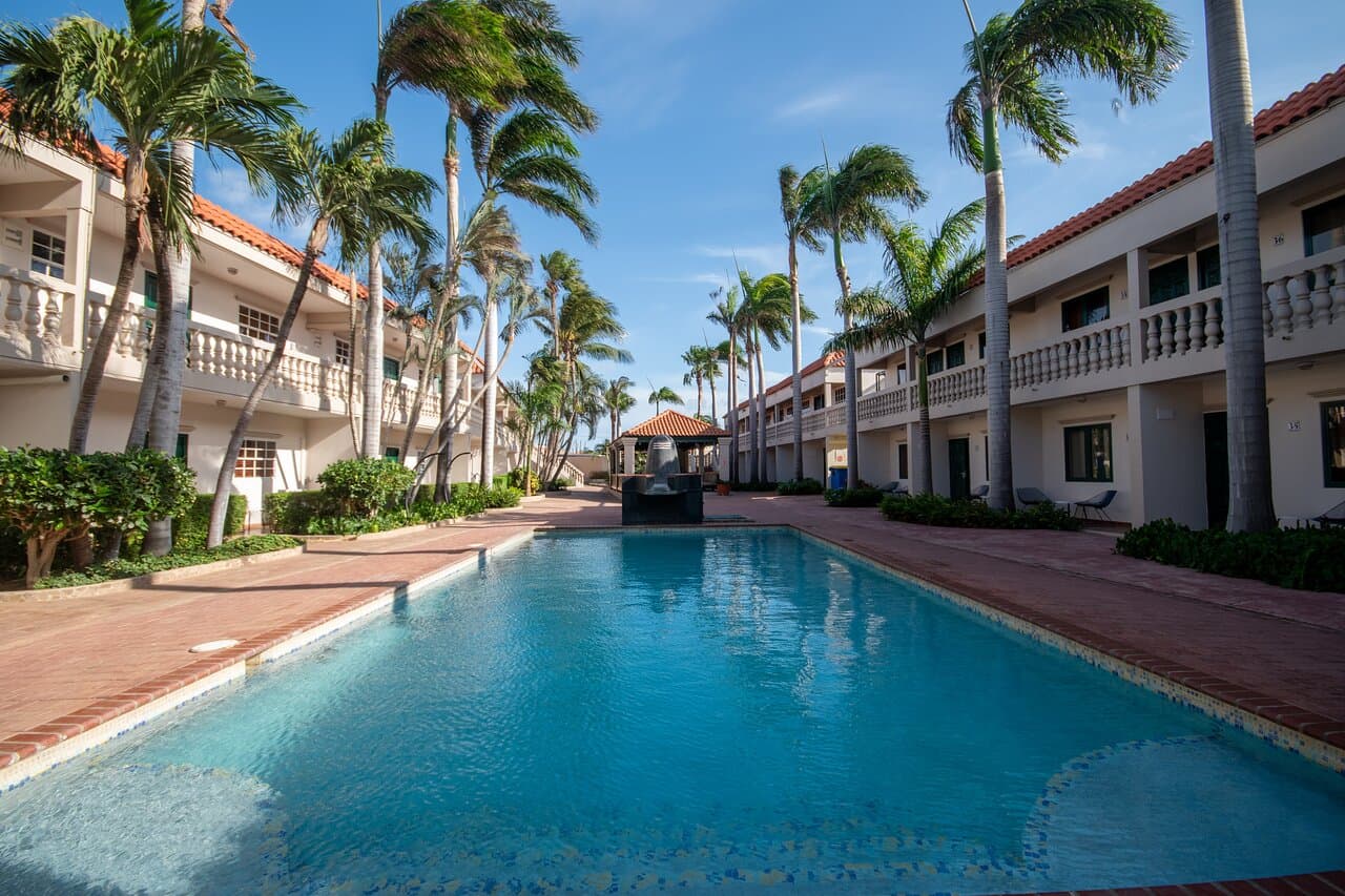Our swimming pool is surrounded by lush palm trees, manicured gardens, and charming two-story buildings. Enjoy a refreshing swim, lounge on the sun deck, or unwind in the cozy gazebo. Experience ultimate relaxation!